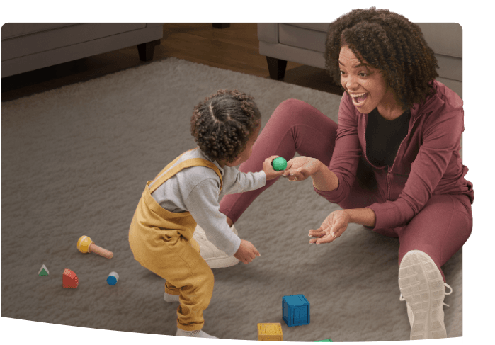 A mother and her toddler playing with toys
